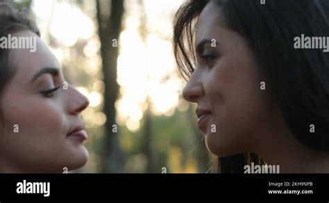 hot lesbian kissing|Two girls french kissing outside at the park. LGBT lesbian couple。